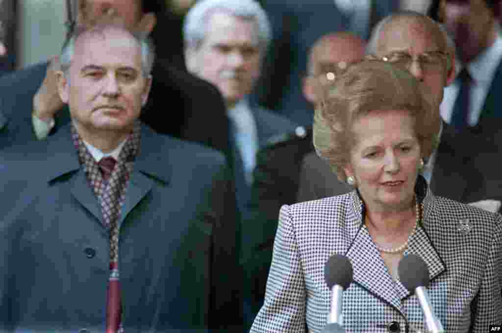 Gorbachev listens to Thatcher speak during a news conference outside 10 Downing Street in London on April 6, 1989.