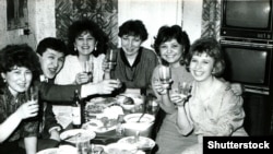 В новогоднюю ночь советские люди собирались с друзьями за столами, заполненными традиционной едой, обменивались подарками и поднимали тост с шампанским за счастье и Новый год.