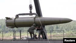 Russian servicemen equip an Iskander tactical missile system in Kubinka, outside Moscow.