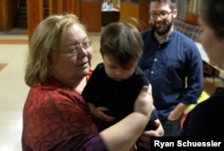 "In order for us to be anywhere successful, we have to put ourselves out there," says Marion Sedorowitz of Brooklyn, shown here holding Alyssa Haughwout's son.