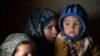 Afghan children warm themselves at a refugee camp on the outskirts of Laghman. (file photo)