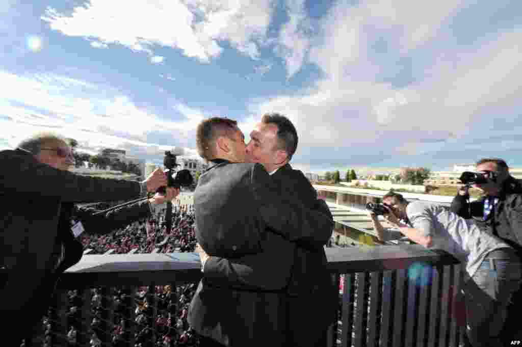Vincent Autin (right) and Bruno Boileau kiss on a balcony in front of a crowd after their marriage, France's first official gay marriage, at the city hall in Montpellier on May 29. France is the 14th country to legalize same-sex marriage, an issue that has divided opinion in the country. (AFP/Gerard Julien)
