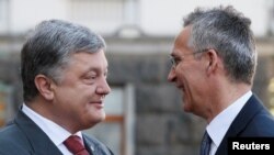 Ukrainian President Petro Poroshenko greets NATO Secretary-General Jens Stoltenberg before a meeting in Kyiv on July 10.