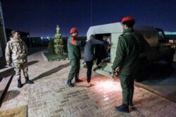 Pro-Haftar military police escort prisoners captured by Haftar's forces, reportedly during their offensive on the western portion of the country, in the eastern city of Benghazi on May 5.