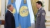 KAZAKHSTAN -- Kazakh President Nursultan Nazarbaev (L) and Deputy Chairman of the National Security Committee Samat Abish attend an awarding ceremony in Astana, May 6, 2014