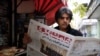 An Iranian man reads a copy of the 'Hamshahri' newspaper outside a kiosk in Tehran. File photo