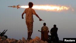 Fighters of Libyan forces allied with the UN-backed government fire a rocket at Islamic State fighters in Sirte on August 4.