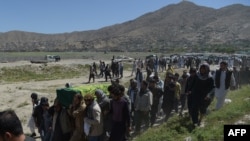 Mourners carry the coffin of one of the 150 victims killed in Kabul on May 31.