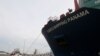 A tug boat tows a Chinese COSCO container vessel as it crosses the Panama Canal. File photo