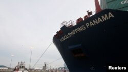 A tug boat tows a Chinese COSCO container vessel as it crosses the Panama Canal. File photo