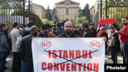 Armenia -- A protester holds a poster during a demontration outside the Armenian parliament against the ratification of the Istanbul Convention, Yerevan, November 1, 2019.