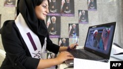 A supporter of President-elect Hassan Rohani works on her laptop in one of his campaign offices in Tehran before the June 14 vote.