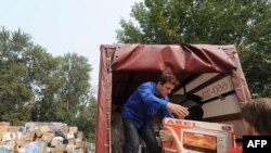 People drop off aid for victims of the Russian wildfires at a collection point in Moscow.