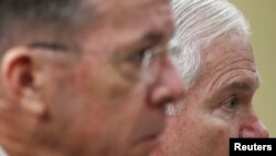 U.S. Secretary of Defense Robert Gates (right) and Admiral Michael Mullen at a hearing in Washington today.