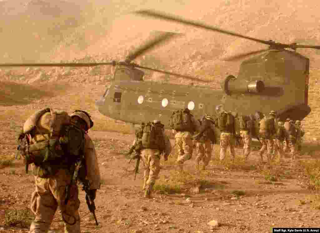 U.S. troops searching for Taliban fighters in mountains near Kandahar in 2003. After the U.S.-led invasion, most defeated Taliban melted away into mountains and villages or escaped into Pakistan.