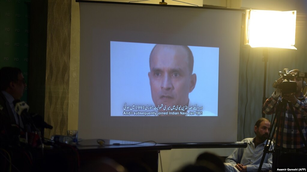 Pakistani journalists watch a video showing Indian national Kulbhushan Jadhav, convicted of espionage, during a press conference in late March.