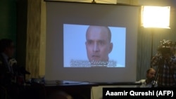Pakistani journalists watch a video showing Indian national Kulbhushan Jadhav, convicted of espionage, during a press conference in late March.