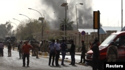 Smoke rises from the site of a bomb attack in central Baghdad on March 14.