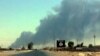 دخان يتصاعد من الموصل في يوم 19 حزيران 2014