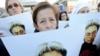 Human rights activists at a rally in honor of slain Russian journalist Anna Politkovskaya in Moscow in 2010.