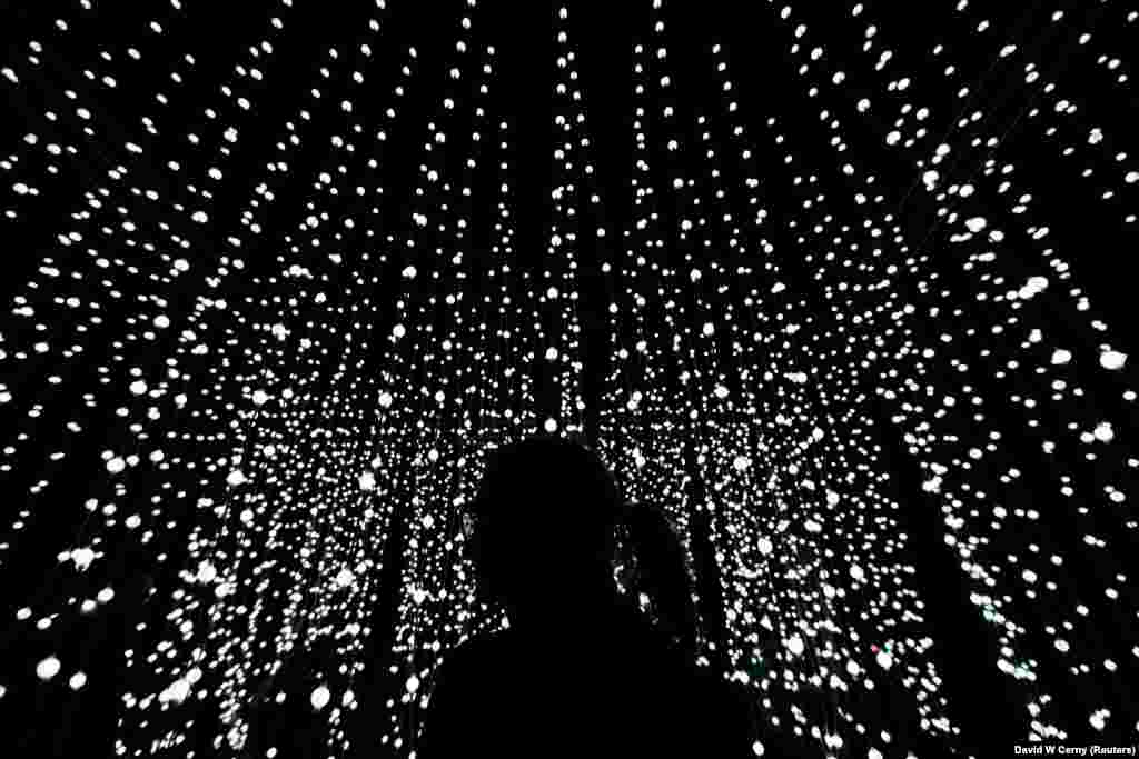 A woman stands in front of an installation during the Signal light festival in Prague. (Reuters/David W. Cerny)