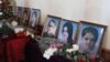 Armenia - Flowers are put by the pictures of six members of an Armenian family murdered in Gyumri during their funeral, 15Jan2015.