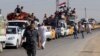 Displaced people riding in trucks and cars head back to their homes in Hawija, on the outskirts of Kirkuk, October 18, 2017