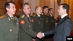 President Dmitry Medvedev (right) met in February with officers appointed to top command ranks.