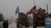 A line of U.S. military vehicles drive through a checkpoint of the Internal Security Forces in Manbij as they head to their base on the outskirts of the northern Syrian city, December 30, 2018. File photo