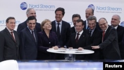 German Chancellor Angela Merkel and Russian President Dmitry Medvedev (center) join other dignitaries at the inauguration ceremony in Lubmin, Germany.