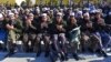 Released Taliban prisoners sit on chairs and pray during a ceremony in Pul-e Charkhi jail on January 4. Observers wonder how many of them will simply rejoin the fight?