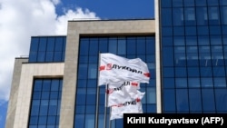 Flags with the logo of Russia's LUKoil fly outside its headquarters in downtown Moscow.