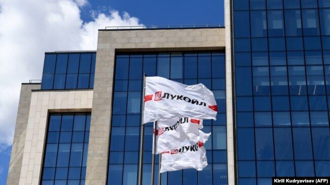 Flags with the logo of Russia's LUKoil fly outside its headquarters in downtown Moscow.