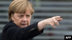 Germany -- Chancellor Angela Merkel gestures as she leaves after a statement after a parliamentary session on the last European Council, Berlin, 20Mar2013