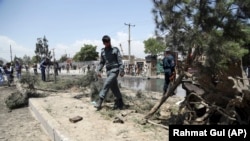 Afghan police arrive at the site of a suicide car bomb in Kabul on May 31.