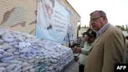 UN Office on Drugs and Crime head Yury Fedotov (right) and Iranian narcotics police chief Hamidreza Housein Abadi look at bags of Afghan-made morphine during a media tour in the city of Zahedan in July 2011.