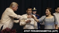 U.S. President Donald Trump (left) toasts with Philippines President Rodrigo Duterte and his common-law wife, Honeylet Avancena, in Manila on November 12.