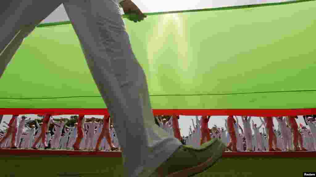 Athletes carry a huge Belarusian national flag during celebrations marking Independence Day in Minsk on July 3. (Reuters/Vasily Fedosenko)