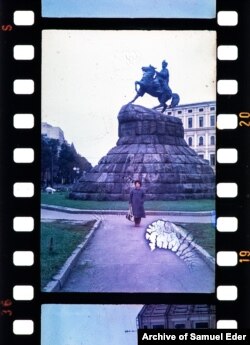 A woman poses in front of the Bohdan Khmelnytsky Monument in Kyiv.