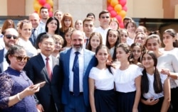 Armenian Prime Minister Nikol Pashinian (center) and Chinese Ambassador Tian Erlong (left) pose for a photo with students of the Chinese-Armenian Friendship School in Yerevan in August 2018.