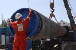 A worker puts a cap on a pipe at a construction site for the Nord Stream 2 gas pipeline in the Leningrad region earlier this year.