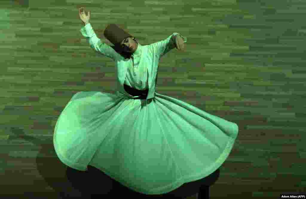 A whirling dervish performs during a ceremony marking the 744th anniversary of the death of Mevlana Jalaluddin Rumi, the father of Sufism, in Konya, Turkey, on December 19.&nbsp;