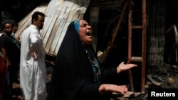 Iraq -- A woman reacts at the scene of a car bomb attack in Baghdad's mainly Shi'ite district of Sadr City, Iraq, May 11, 2016.