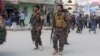 Afghan security forces keep watch near the site of a suicide bombing in Kabul on March 9.