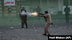 Співробітник силових структур Іраку застосовує сльозогінний газ проти демонстрантів. Багдад, 10 листопада 2019 року