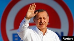 Turkey -- Turkey's Prime Minister and presidential candidate Tayyip Erdogan greets his supporters during an election rally in Istanbul August 3, 2014. 