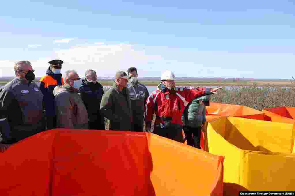 Russian Emergency Situations Minister Yevgeny Zinichev (front row, second from right) and Krasnoyarsk Governor Aleksandr Uss (front row, second from left) inspect the aftermath of the accident on June 4.&nbsp; &nbsp;