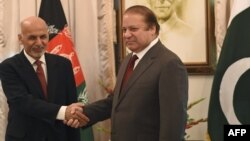 Afghan President Ashraf Ghani (L) and Pakistani Prime Minister Nawaz Sharif shake hands at the Prime Minister House in Islamabad on November 15, 2014.