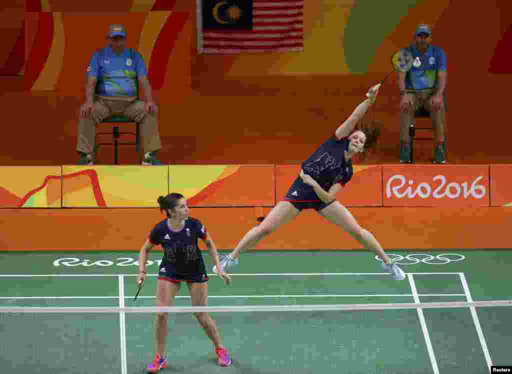 Great Britain&#39;s Lauren Smith jumps to return a shot, as teammate Heather Olver looks on during their badminton match against Malaysia.&nbsp;