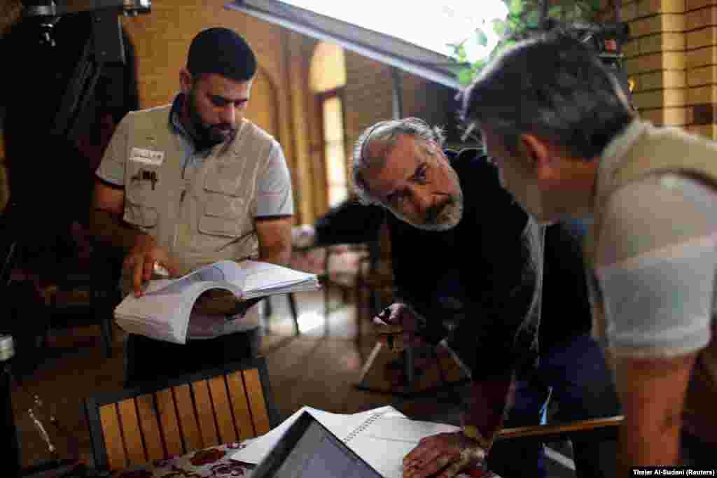 IRAQ - Director Hassan Husni speaks to the director of photography while filming the hotel TV series, which is being filmed and broadcast during the Muslim holy month of Ramadan, in Baghdad, Iraq May 12, 2019